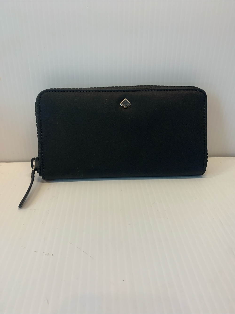 kate spade black zip-around wallet with spade emblem